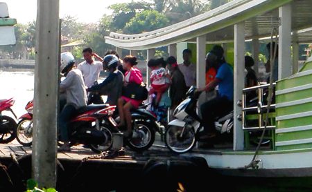 Motorbikes disembark ferry at Samut Sakhon