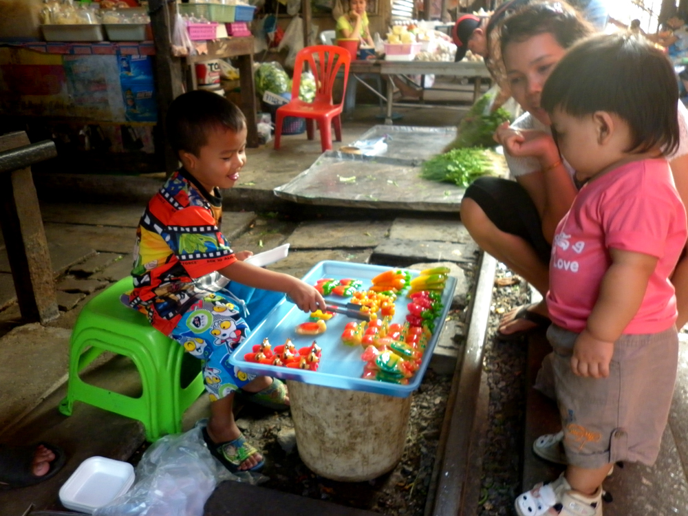 Fresh faced youn g vendor sweetening the customers